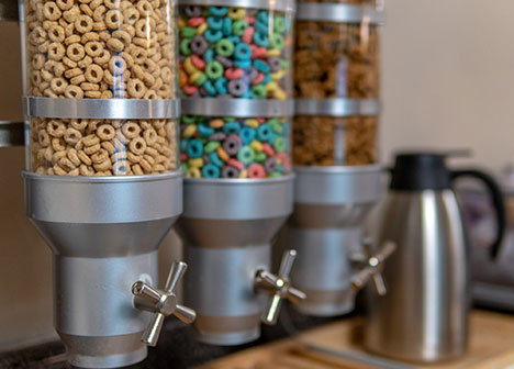 Self-serve dispensers filled with colorful cereal