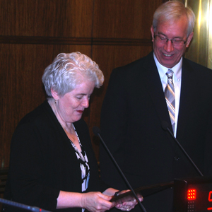 Board of Commissioners Chair Reinhardt presents plaque to outgoing chair McDonough